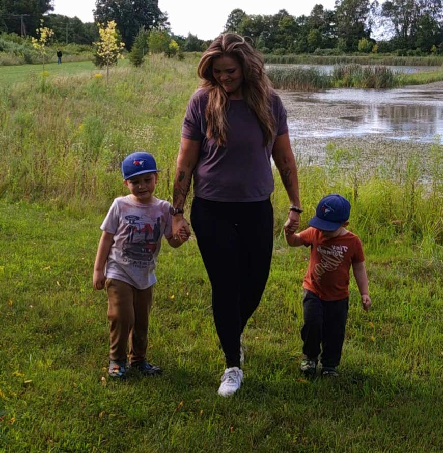 Coach walking outside with her family.