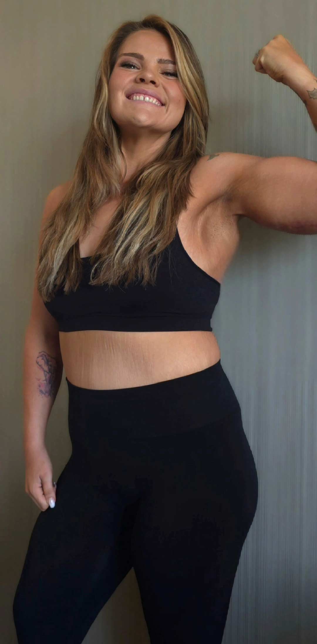 Coach showing her muscles and body transformation.